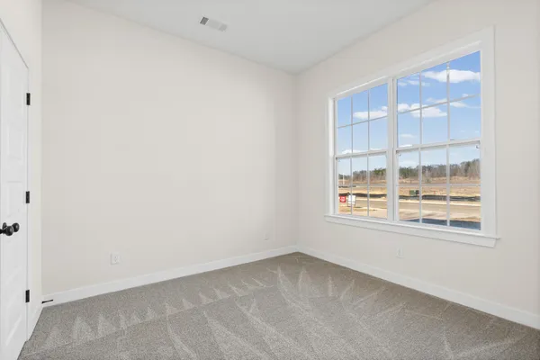 a kitchen with a stove and a wooden floor