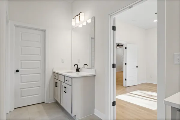 a view of a room with wooden floor and a ceiling fan