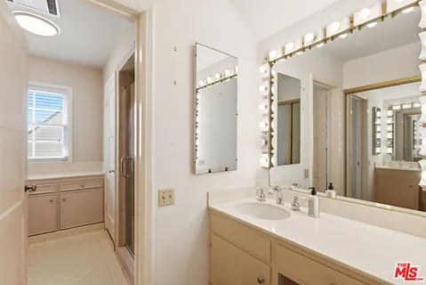 a bathroom with a sink double vanity and windows