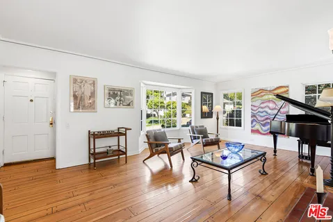 a living room with furniture a rug and a wooden floor