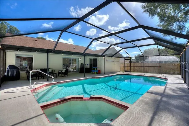 a swimming pool with outdoor seating and yard