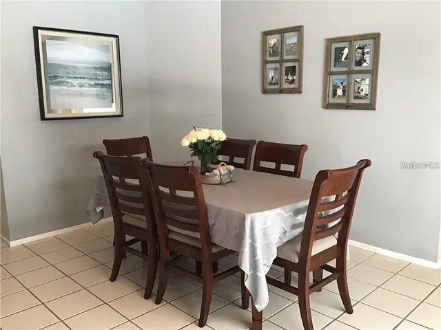a dining room with furniture and window