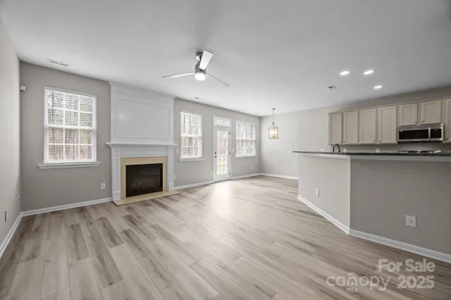 a view of a kitchen with a sink and wooden floor
