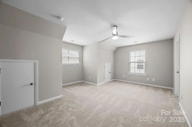 a view of an empty room with a ceiling fan
