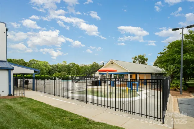 a view of a bench in the garden near a lake