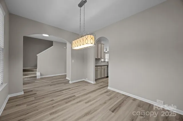 a kitchen with granite countertop a sink stainless steel appliances white cabinets and a granite counter tops