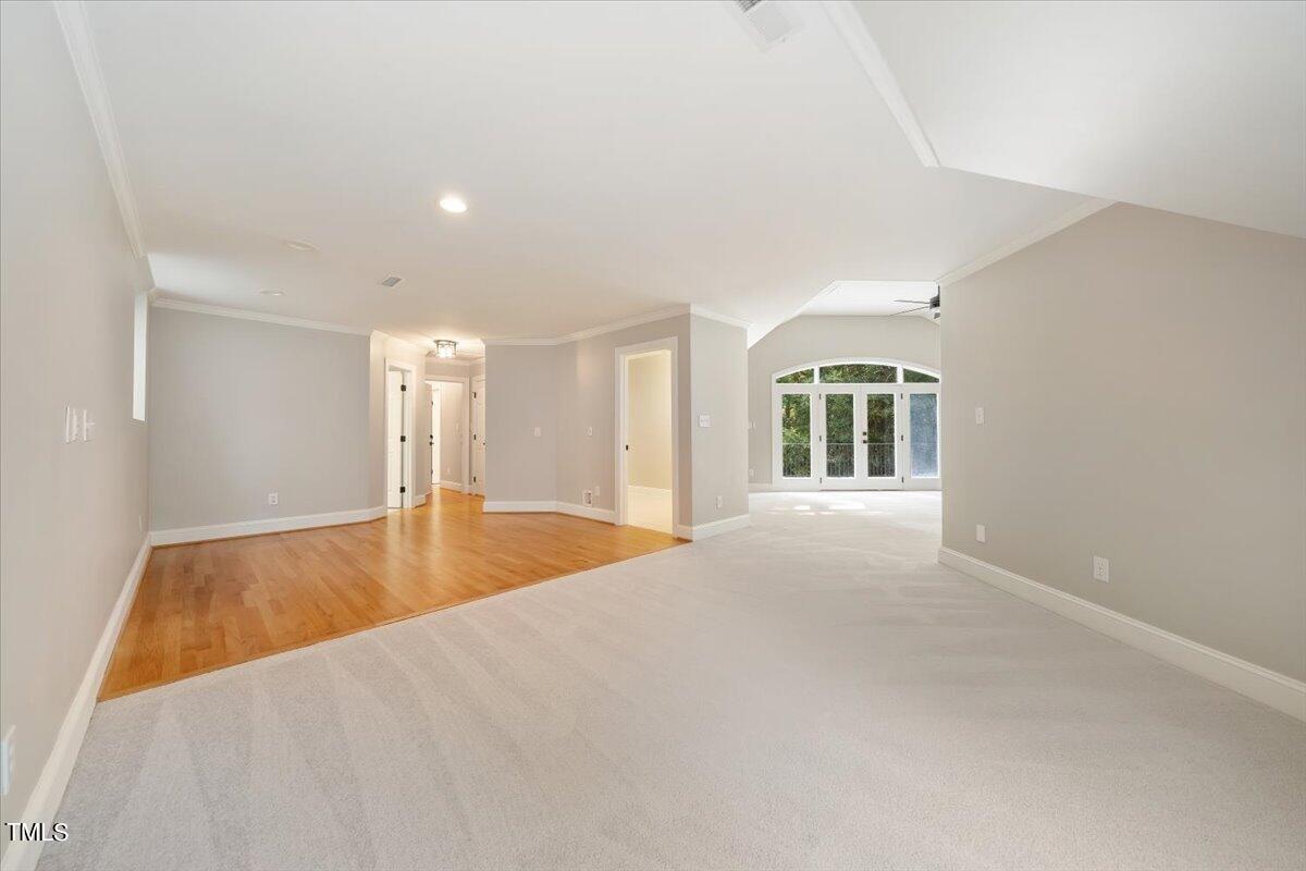 6300 Swallow Cove Lane Raleigh, NC 27614 - Photo 45 of 67 a view of an empty room with wooden floor and a window
