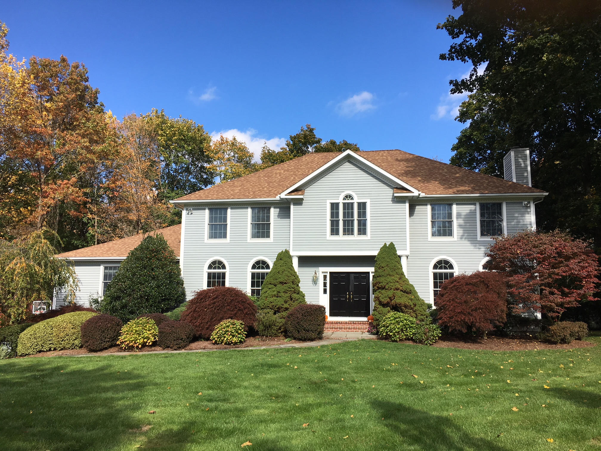 152 Old Studio Road New Canaan, CT 06840 - Photo 1 of 35 a front view of a house with a garden