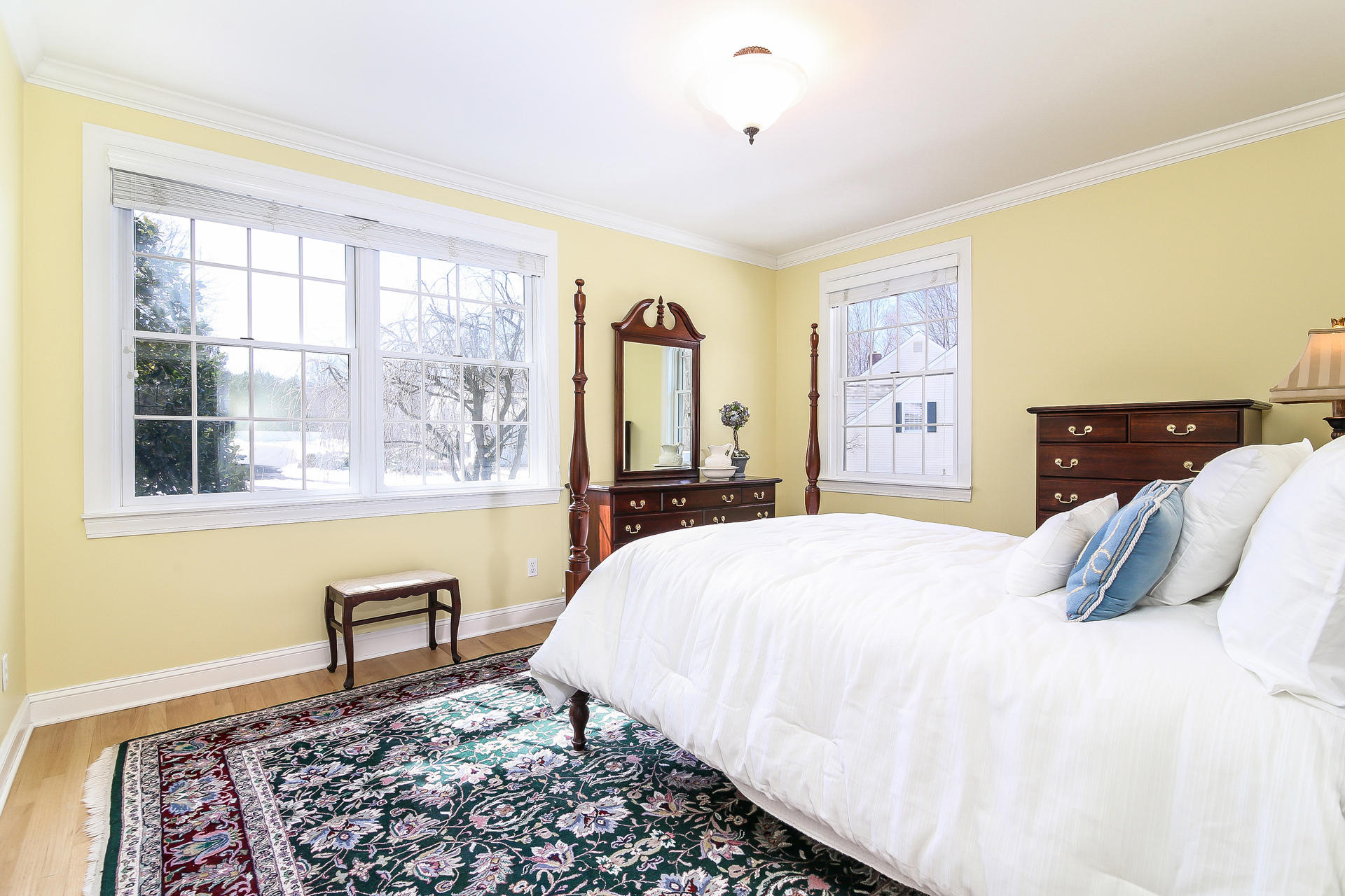 152 Old Studio Road New Canaan, CT 06840 - Photo 18 of 35 a bedroom with a bed and a dresser next to a window