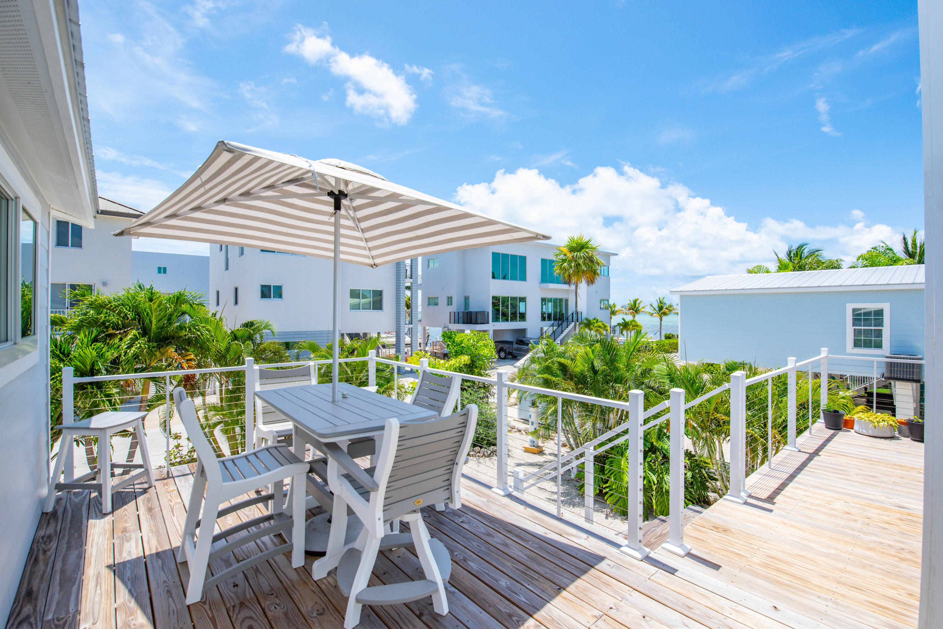930 80th Street Marathon, FL 33050 - Photo 29 of 49 a view of a chair and table on the wooden deck