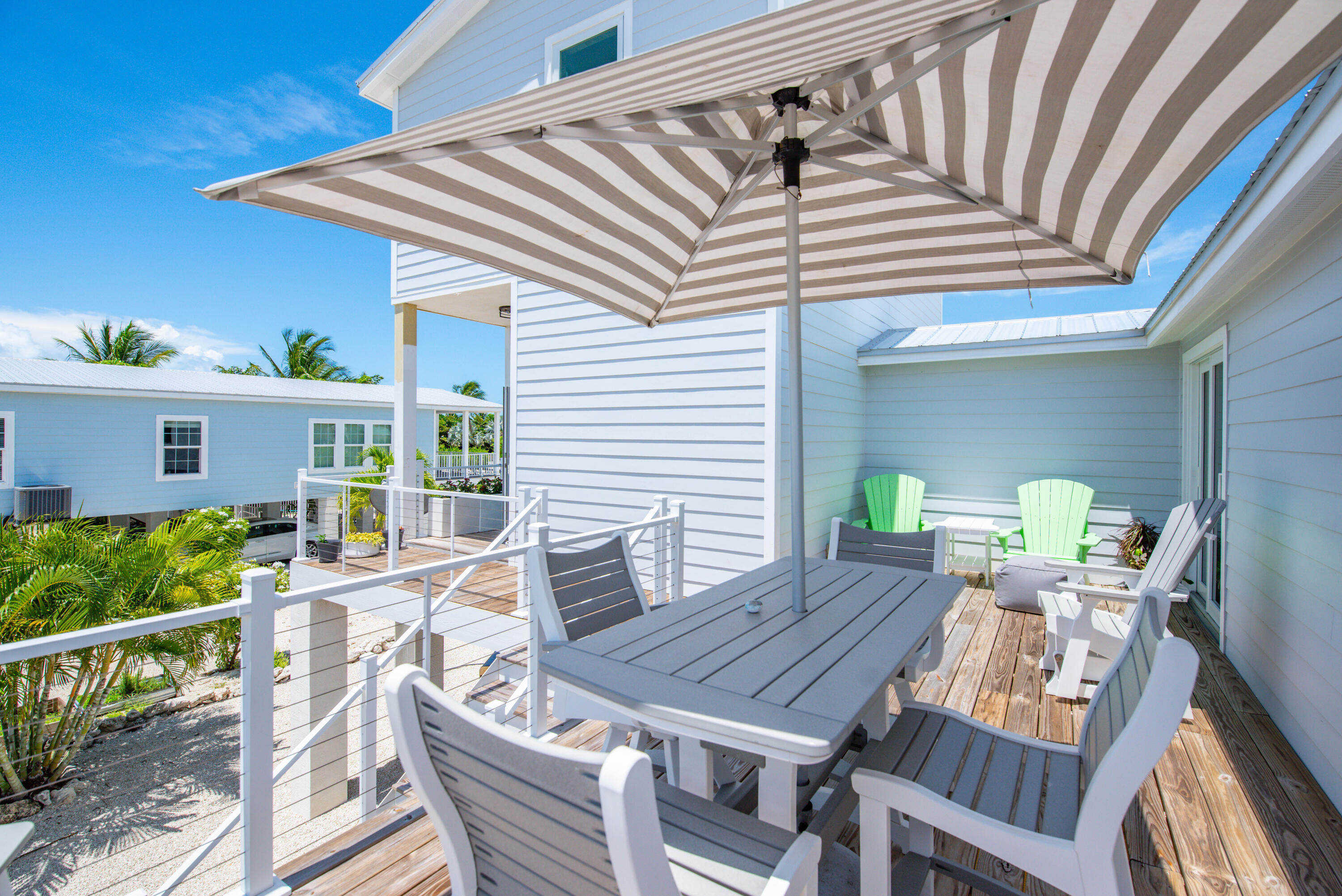 930 80th Street Marathon, FL 33050 - Photo 31 of 49 a view of a patio with table and chairs with wooden floor and plants