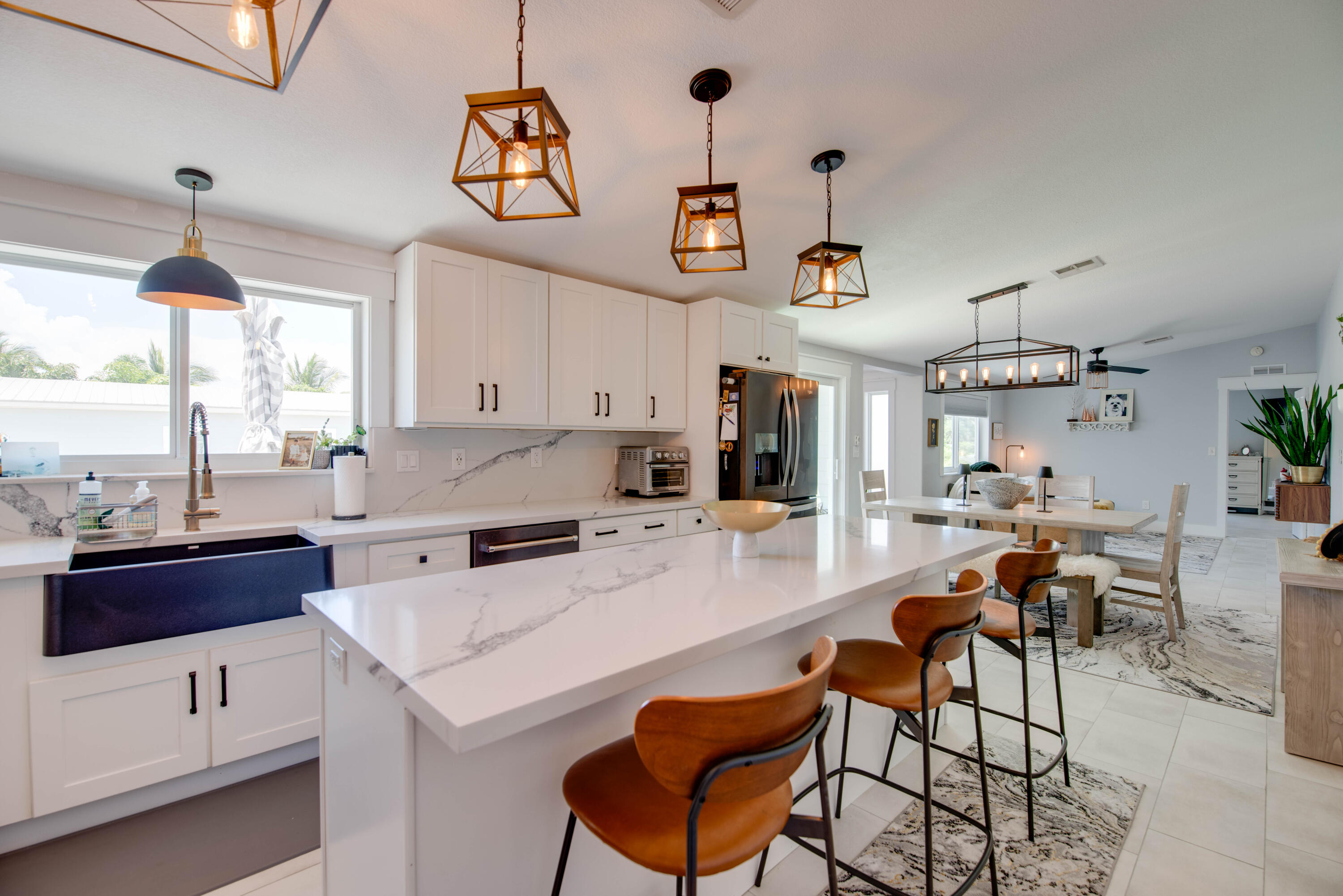 930 80th Street Marathon, FL 33050 - Photo 6 of 49 a kitchen with a dining table chairs and white cabinets
