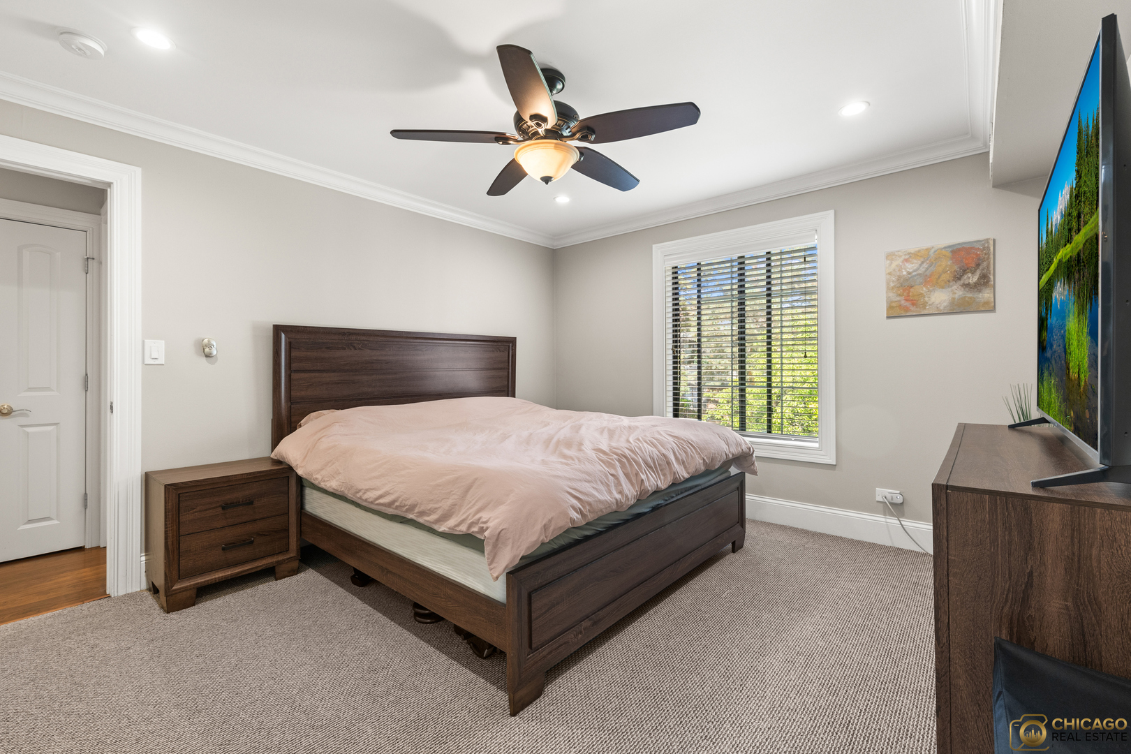 1631 West Partridge Court, Unit 8 Arlington Heights, IL 60004 - Photo 15 of 26 a bedroom with a bed and a flat screen tv