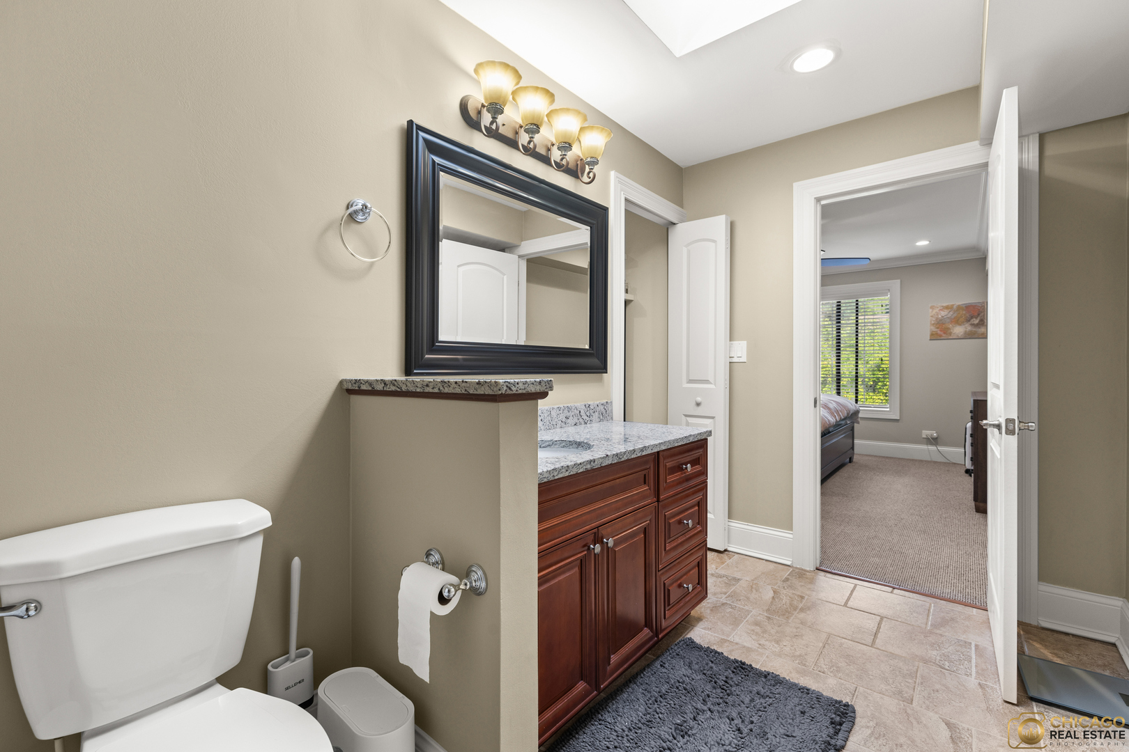 1631 West Partridge Court, Unit 8 Arlington Heights, IL 60004 - Photo 19 of 26 a bathroom with a toilet sink and mirror