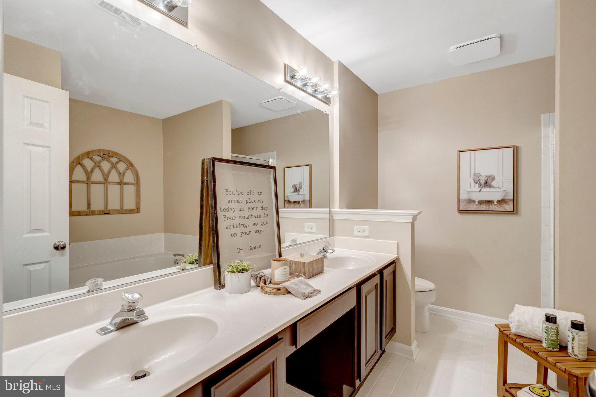 7706 Shadowcreek Terrace Springfield, VA 22153 - Photo 16 of 30 a bathroom with a sink double vanity and a mirror
