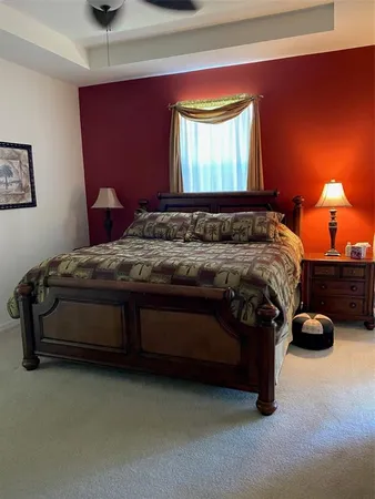 a bedroom with a bed and a lamp