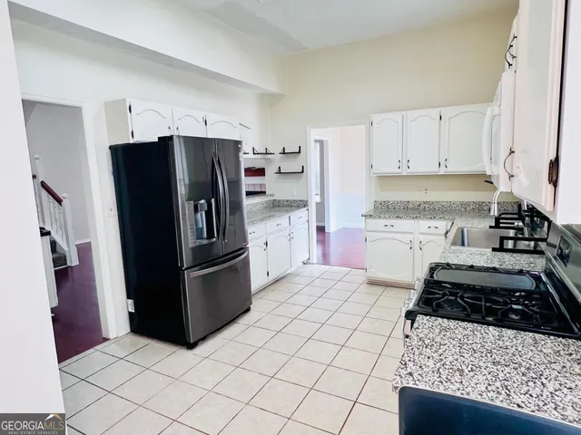 a view of a hallway with furniture and living room