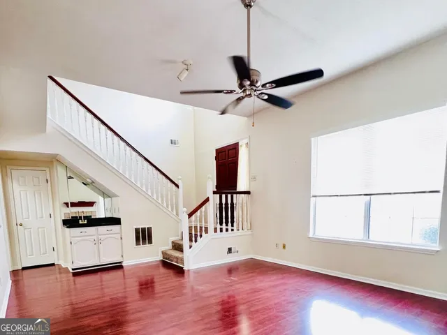 a view of staircase with wooden floor and window