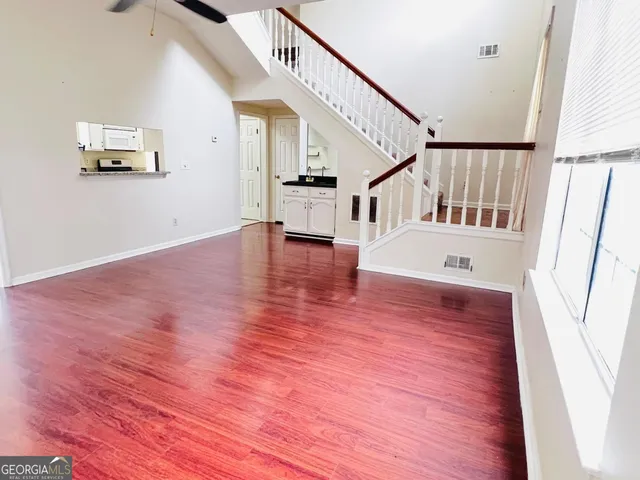 a view of entryway and hall with wooden floor