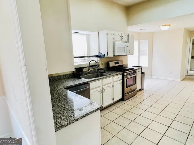 a kitchen with a sink a stove and refrigerator