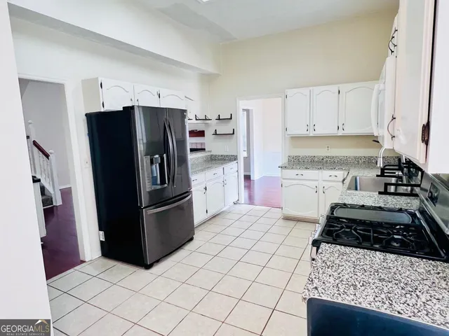 a kitchen with a stove a refrigerator and a sink