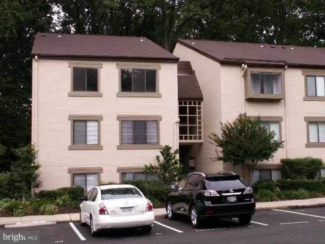 11737 Ledura Court, Unit 201 Reston, VA 20191 - Photo 2 of 5 a car parked in front of a white house