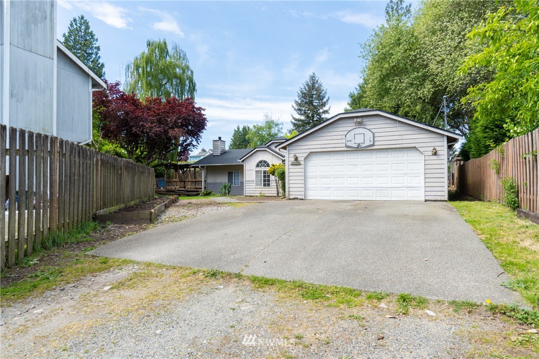 10837 4th Avenue South Seattle, WA 98168 - Photo 2 of 25 a front view of a house with a yard and garage