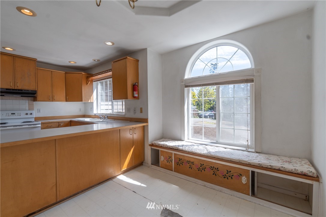 10837 4th Avenue South Seattle, WA 98168 - Photo 15 of 25 a large kitchen with stainless steel appliances granite countertop a sink and a stove