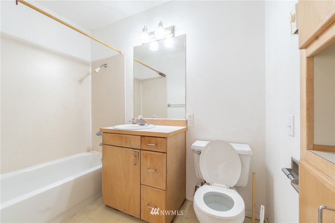 10837 4th Avenue South Seattle, WA 98168 - Photo 18 of 25 a bathroom with a toilet sink and mirror