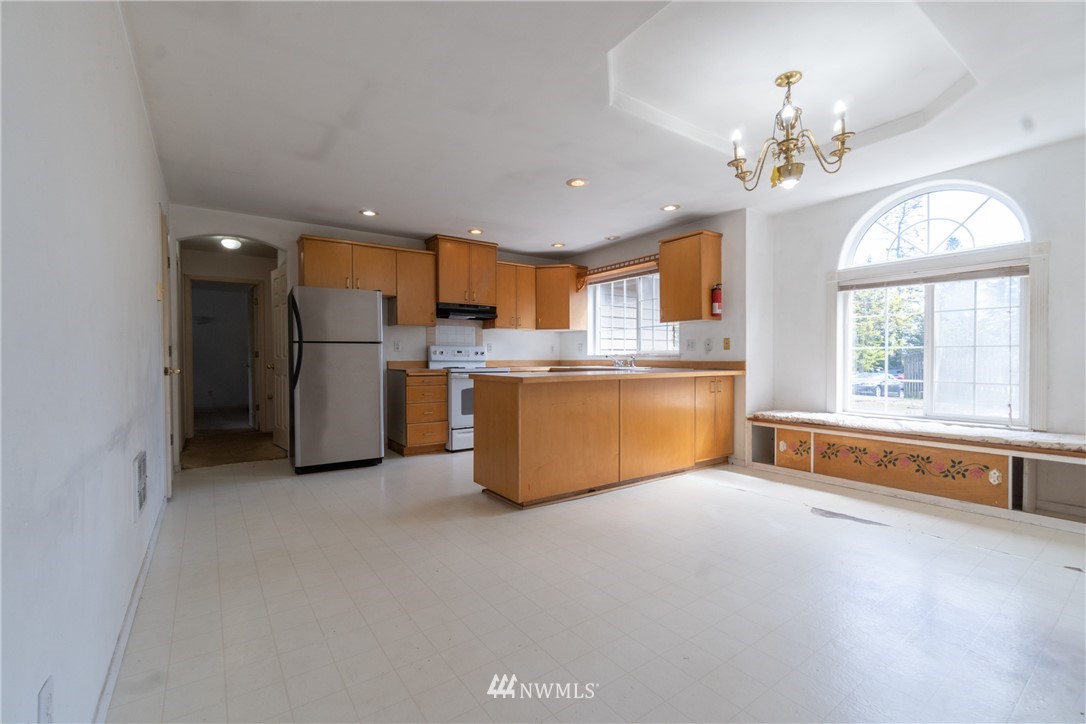 10837 4th Avenue South Seattle, WA 98168 - Photo 8 of 25 a living room with stainless steel appliances kitchen island granite countertop furniture and a chandelier