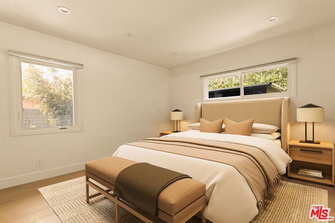 4841 Don Pio Drive Woodland Hills, CA 91364 - Photo 13 of 20 a bedroom with a bed two lamps and a large window with outer view