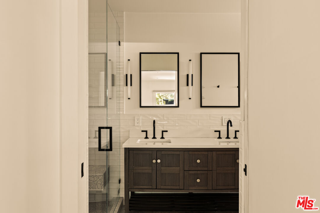 4841 Don Pio Drive Woodland Hills, CA 91364 - Photo 14 of 20 a bathroom with a double vanity sink and mirror