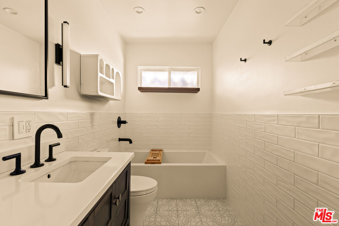 4841 Don Pio Drive Woodland Hills, CA 91364 - Photo 15 of 20 a bathroom with a sink a toilet and bathtub