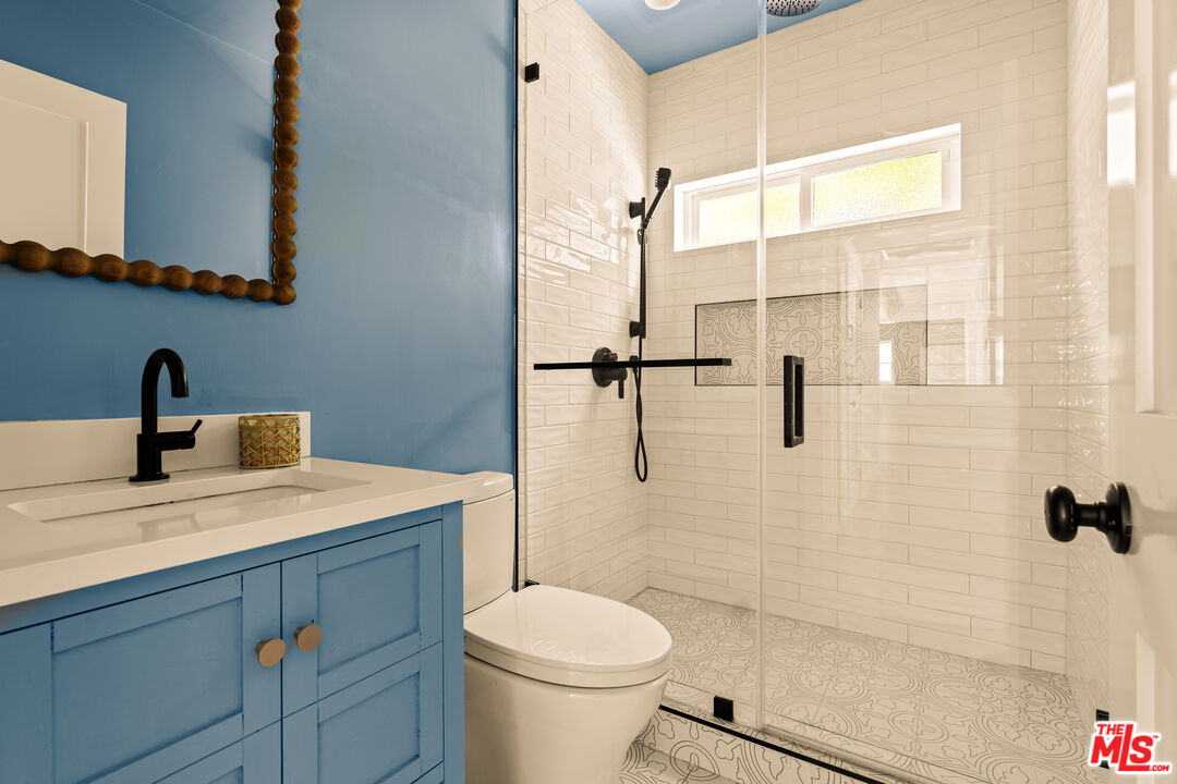 4841 Don Pio Drive Woodland Hills, CA 91364 - Photo 17 of 20 a bathroom with a sink a toilet and shower