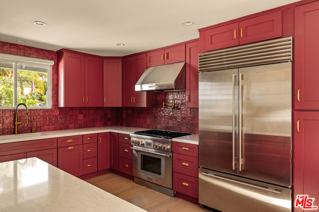 4841 Don Pio Drive Woodland Hills, CA 91364 - Photo 2 of 20 a kitchen with stainless steel appliances granite countertop a refrigerator and a sink