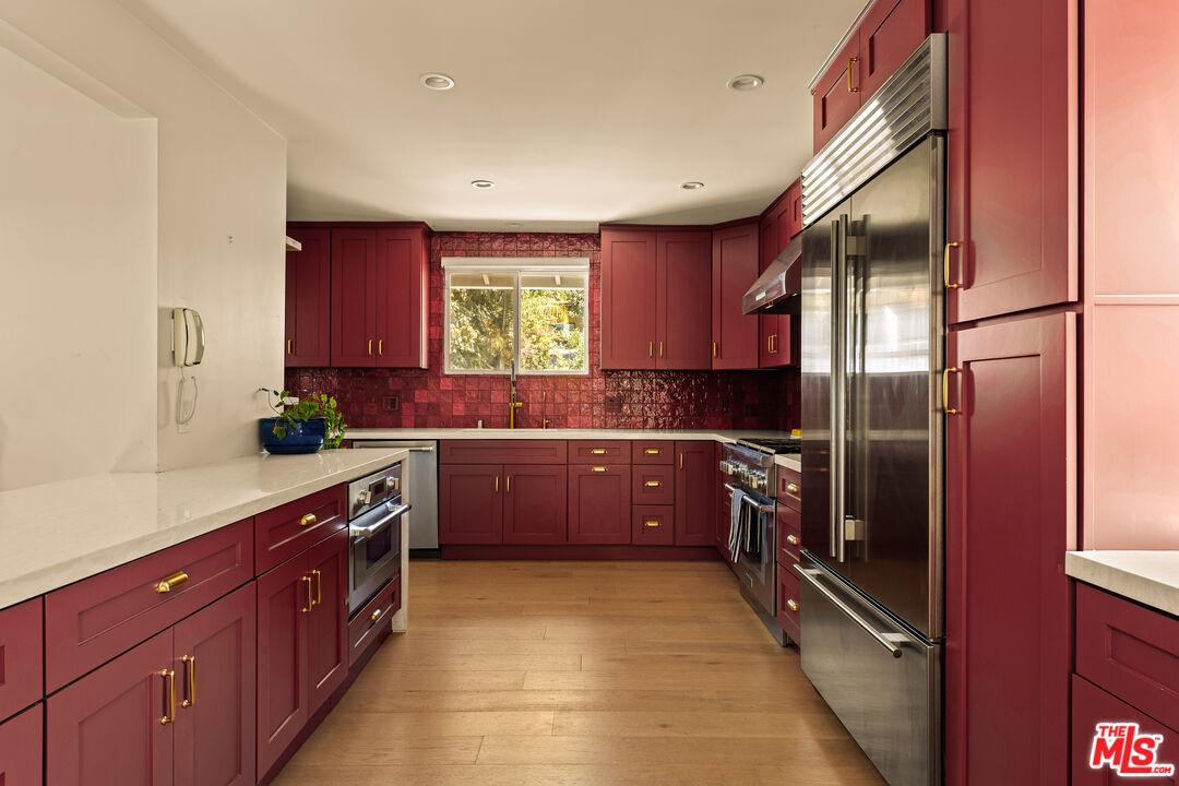 4841 Don Pio Drive Woodland Hills, CA 91364 - Photo 10 of 20 a kitchen with stainless steel appliances granite countertop a sink a stove and refrigerator