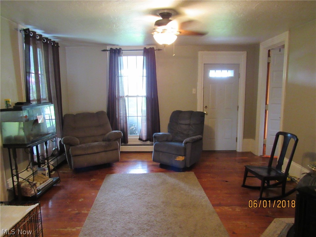 4444 Austin Road Geneva, OH 44041 - Photo 7 of 26 Living Room with hardwood floors and wood stove. This room could easily be used as a dining room.
