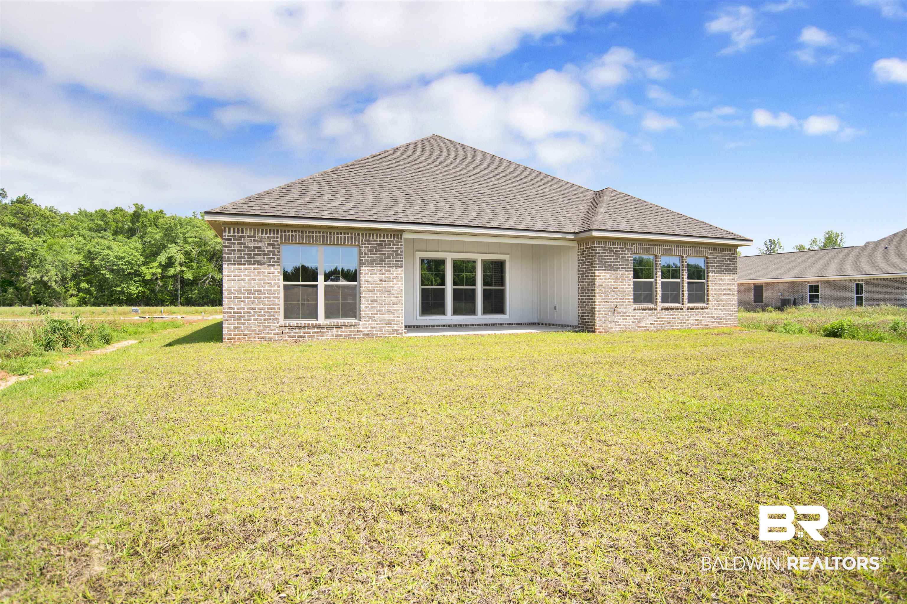 27331 Patch Pl Loop Daphne, AL 36526 - Photo 48 of 62 Rear view of house with a yard, a patio, brick siding, and a shingled roof