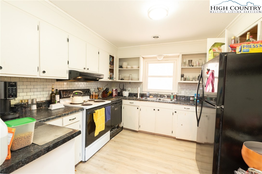 182 Owens Drive Boone, NC 28607 - Photo 11 of 20 a kitchen with stainless steel appliances granite countertop a stove a sink dishwasher and a refrigerator with wooden floor
