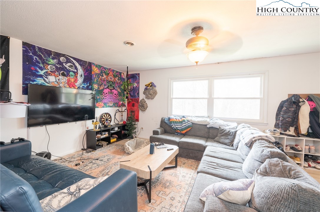 182 Owens Drive Boone, NC 28607 - Photo 8 of 20 a living room with furniture and a flat screen tv