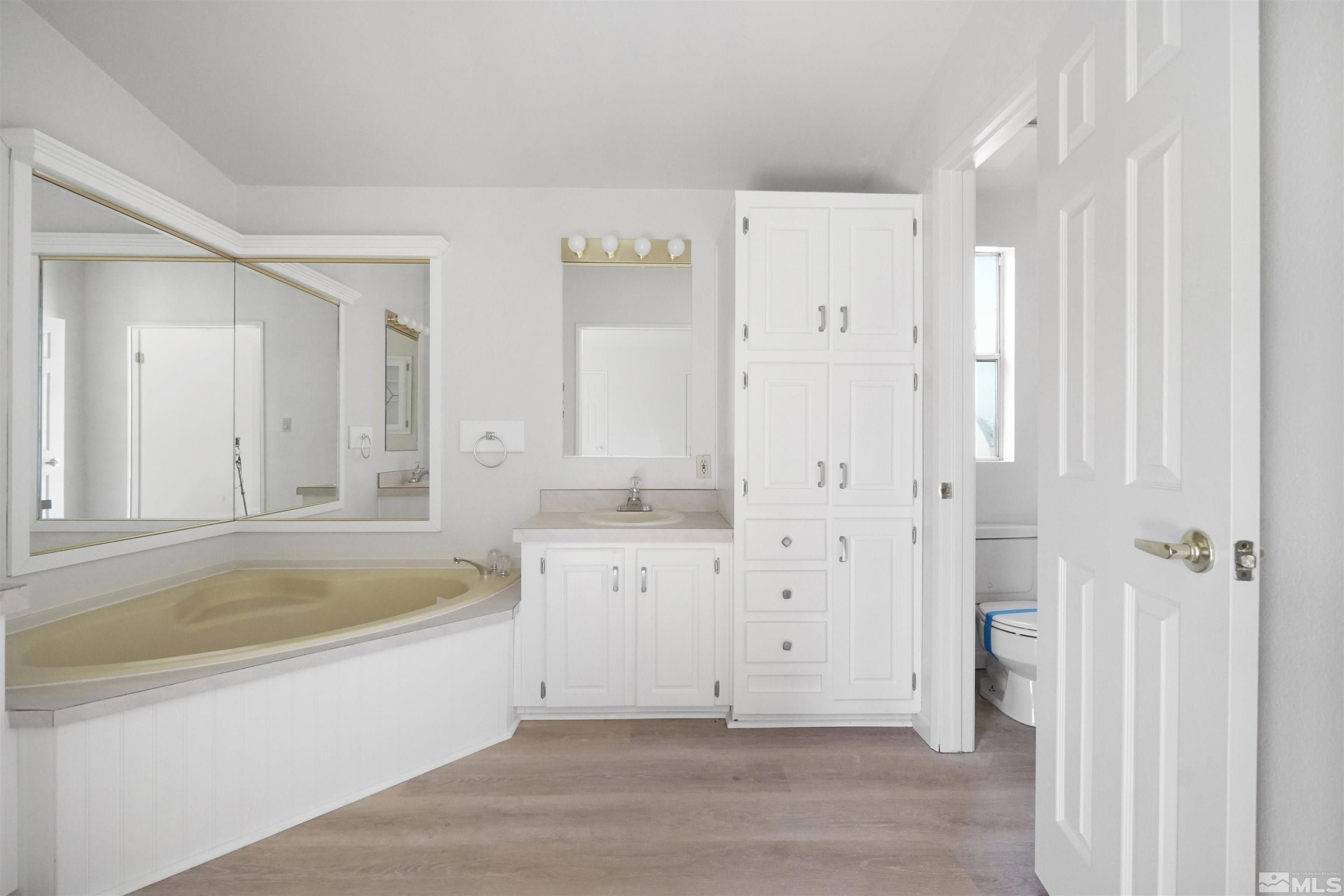 15095 Pinion Drive Reno, NV 89521 - Photo 14 of 18 a bathroom with a tub a sink and a shower