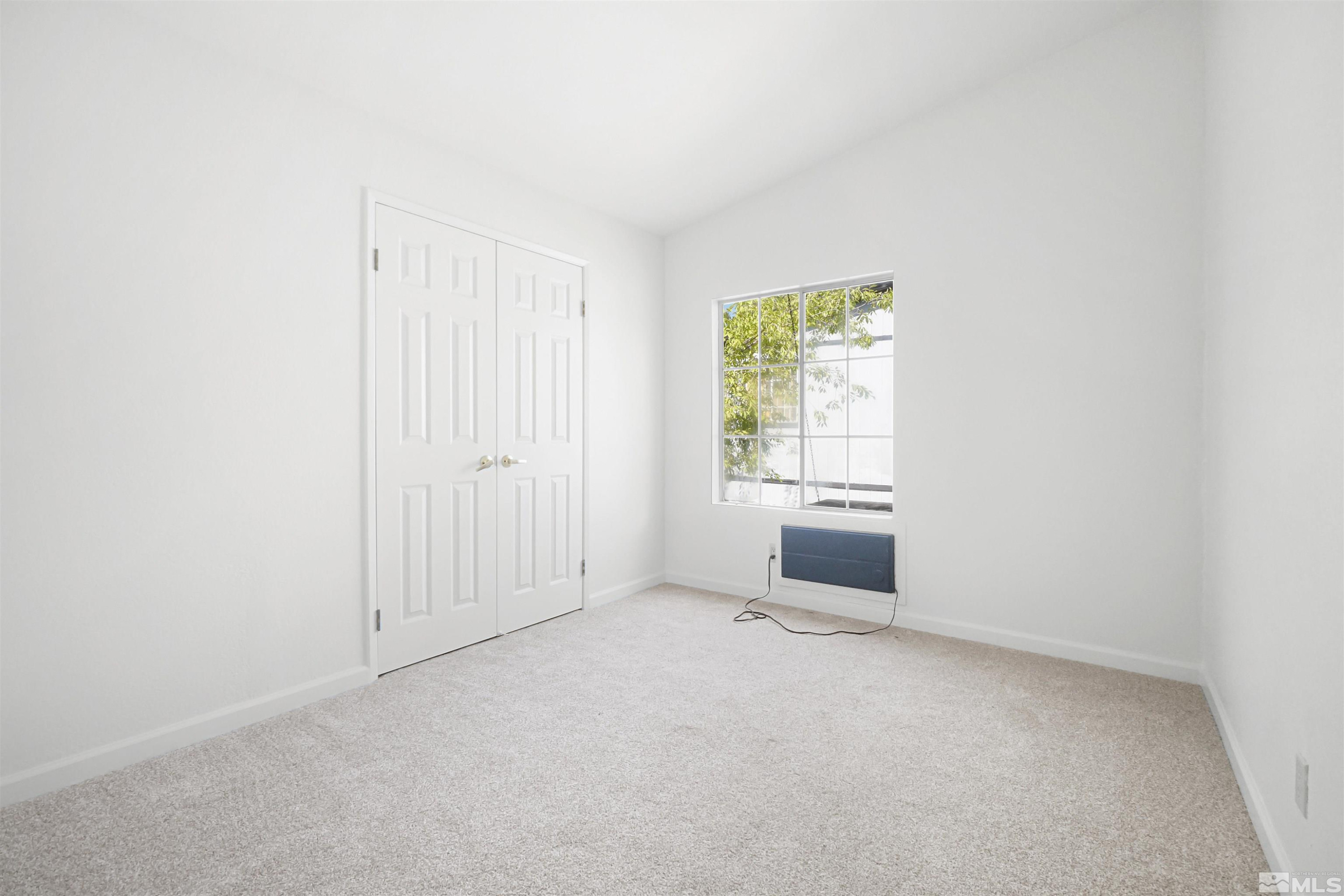 15095 Pinion Drive Reno, NV 89521 - Photo 8 of 18 an empty room with windows