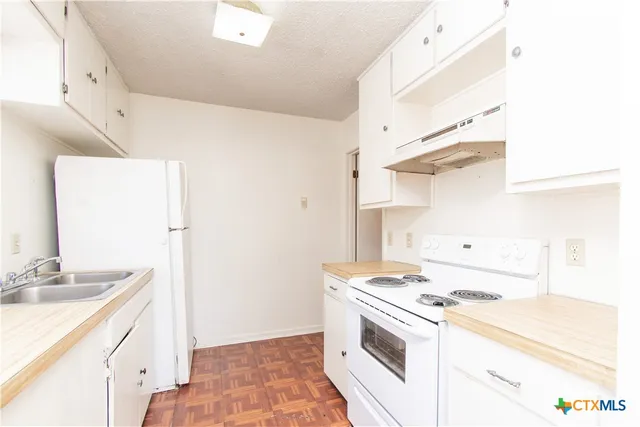 a kitchen with a stove and a sink