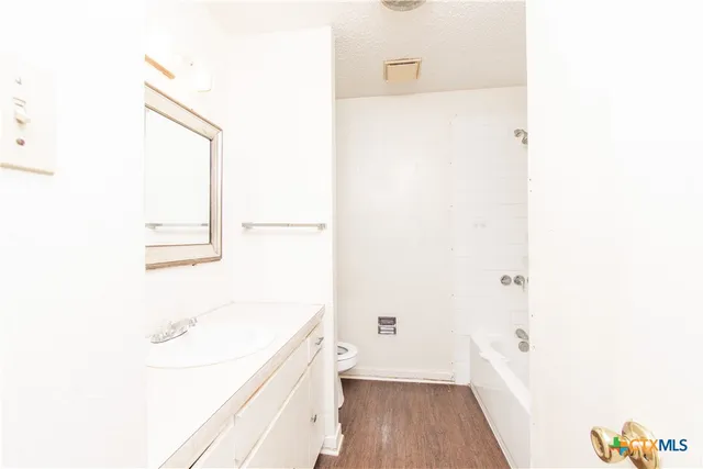 a bathroom with a bathtub and a sink