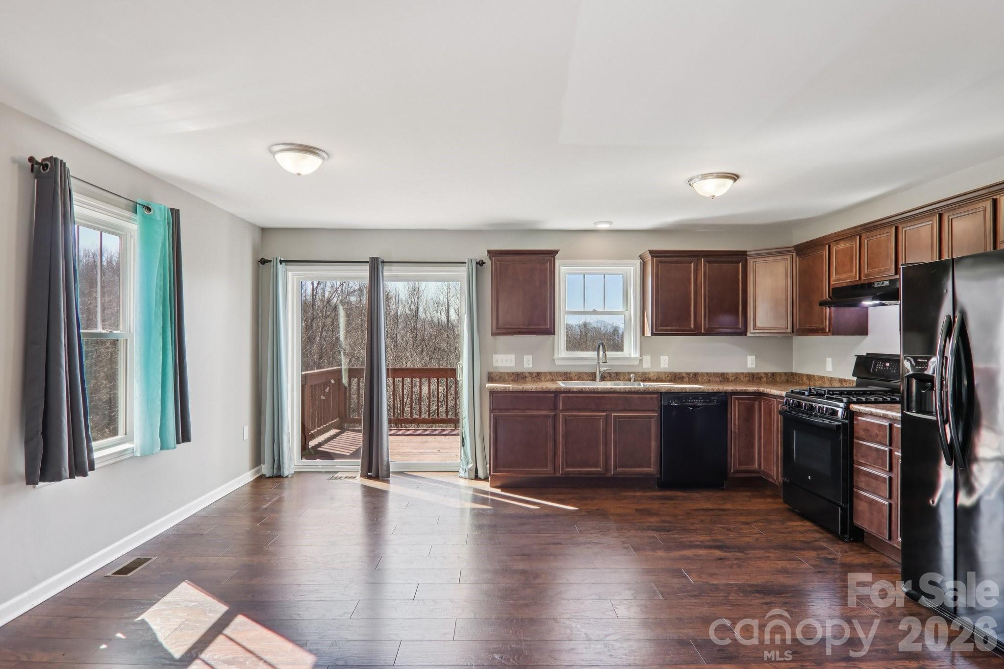 751 Hutch Mountain Road Fletcher, NC 28732 - Photo 17 of 48 a large kitchen with kitchen island granite countertop a large window and stainless steel appliances