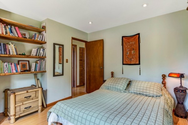 83-5366 Painted Church Road Captain Cook, HI 96704 - Photo 11 of 25 a bedroom with a bed and a book shelf