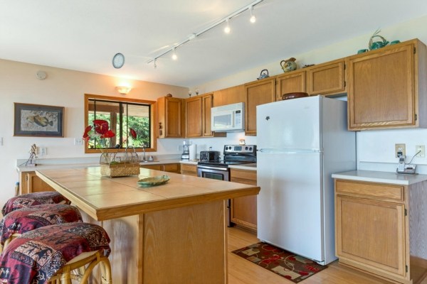 83-5366 Painted Church Road Captain Cook, HI 96704 - Photo 6 of 25 a kitchen with stainless steel appliances granite countertop a refrigerator and a stove top oven