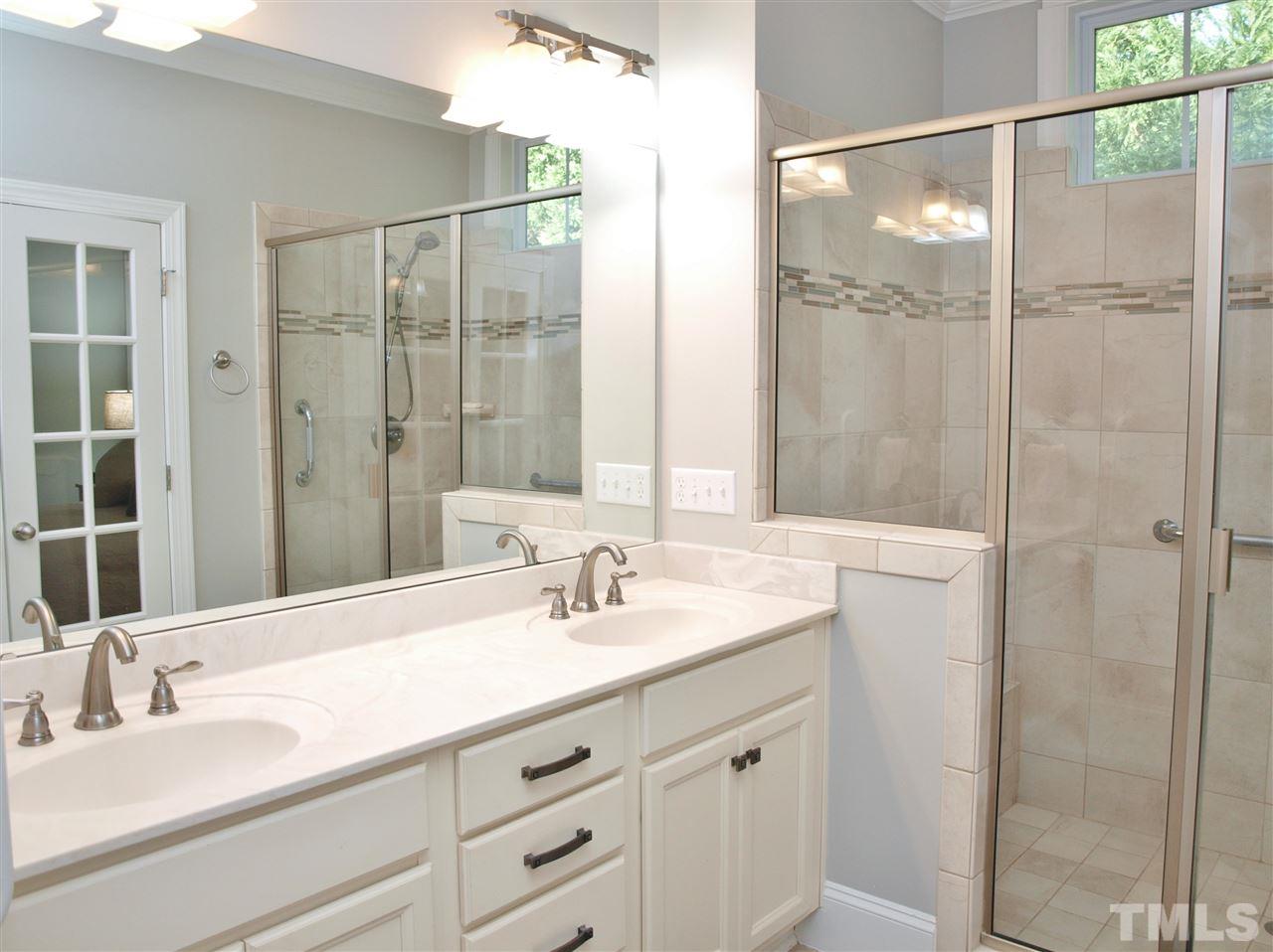 300 Bon Marche Lane Raleigh, NC 27615 - Photo 11 of 25 a bathroom with a double vanity sink and a mirror