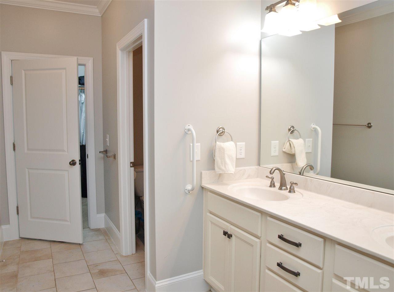 300 Bon Marche Lane Raleigh, NC 27615 - Photo 12 of 25 a bathroom with a sink and a mirror