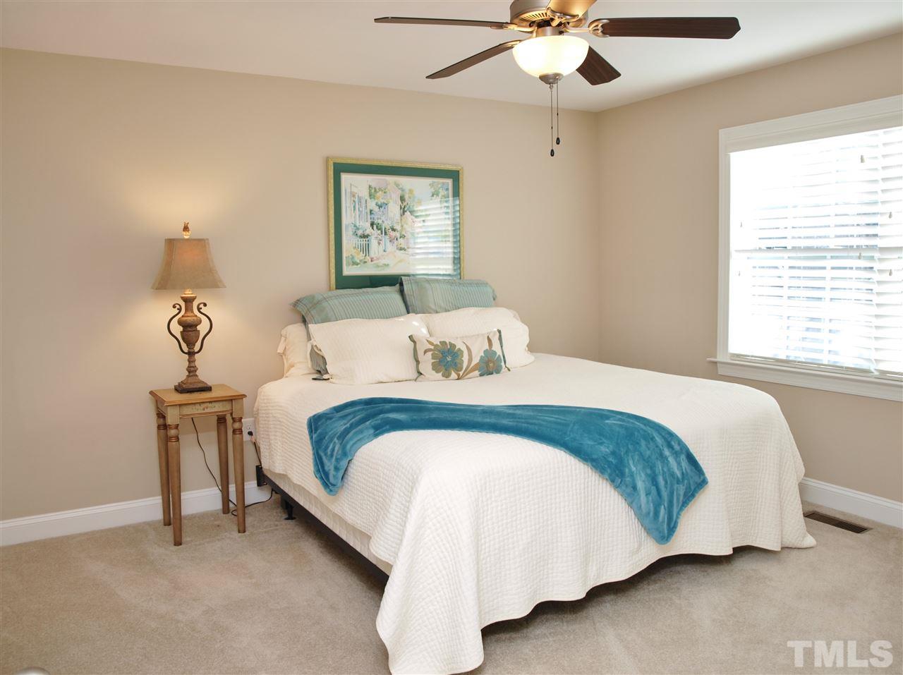 300 Bon Marche Lane Raleigh, NC 27615 - Photo 15 of 25 a bedroom with a bed and a chandelier